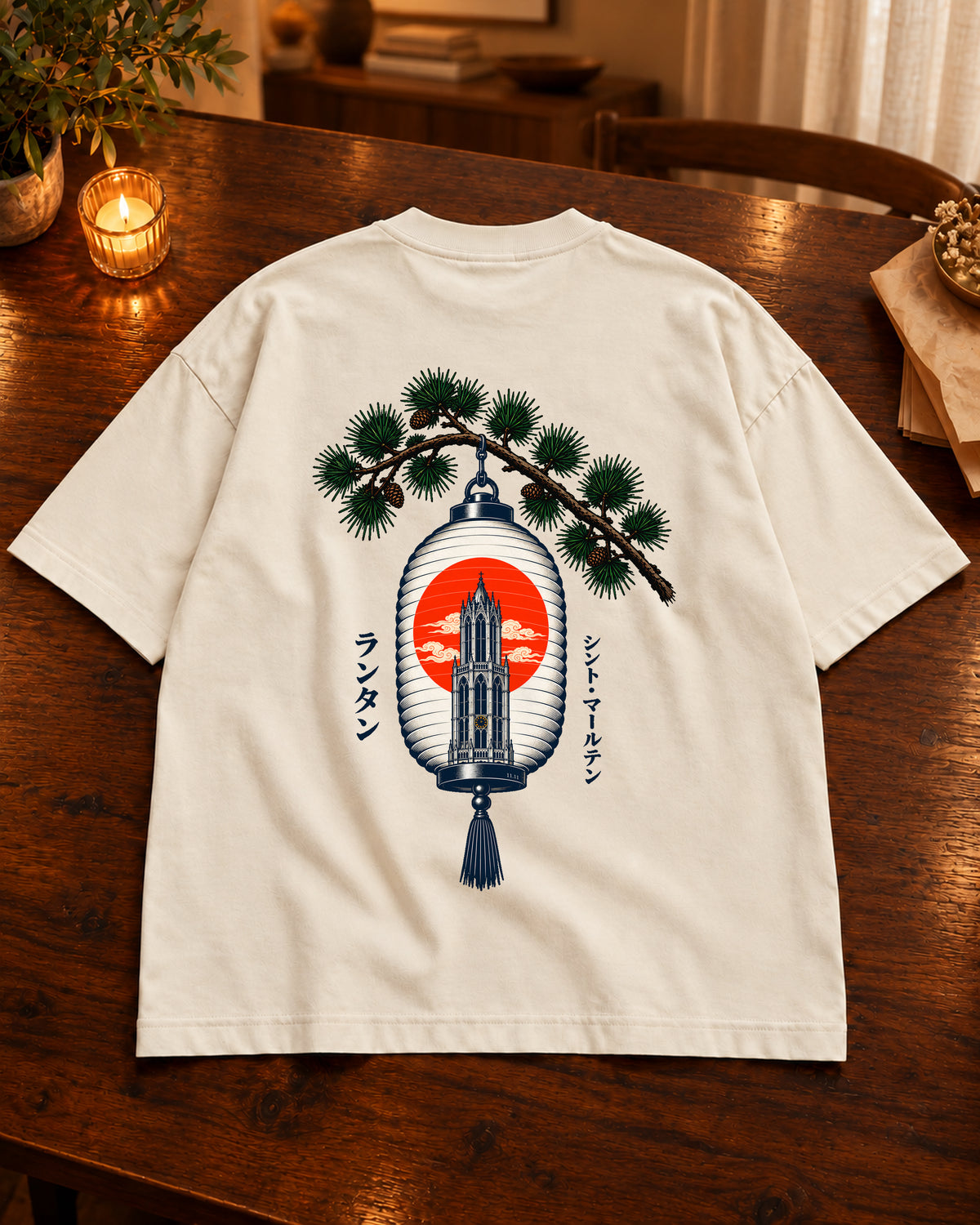 Fudō Tee 不動 | Lantern — Vintage White — volledig kledingstuk met rugontwerp op een tafel thuis bij kaarslicht