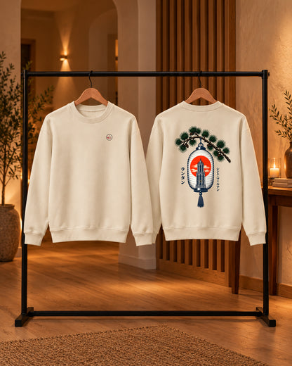 Nagasode Sweater 長袖 | Lantern — Parchment — voor- en achterkant aan houten hangers in huis met kaarslicht