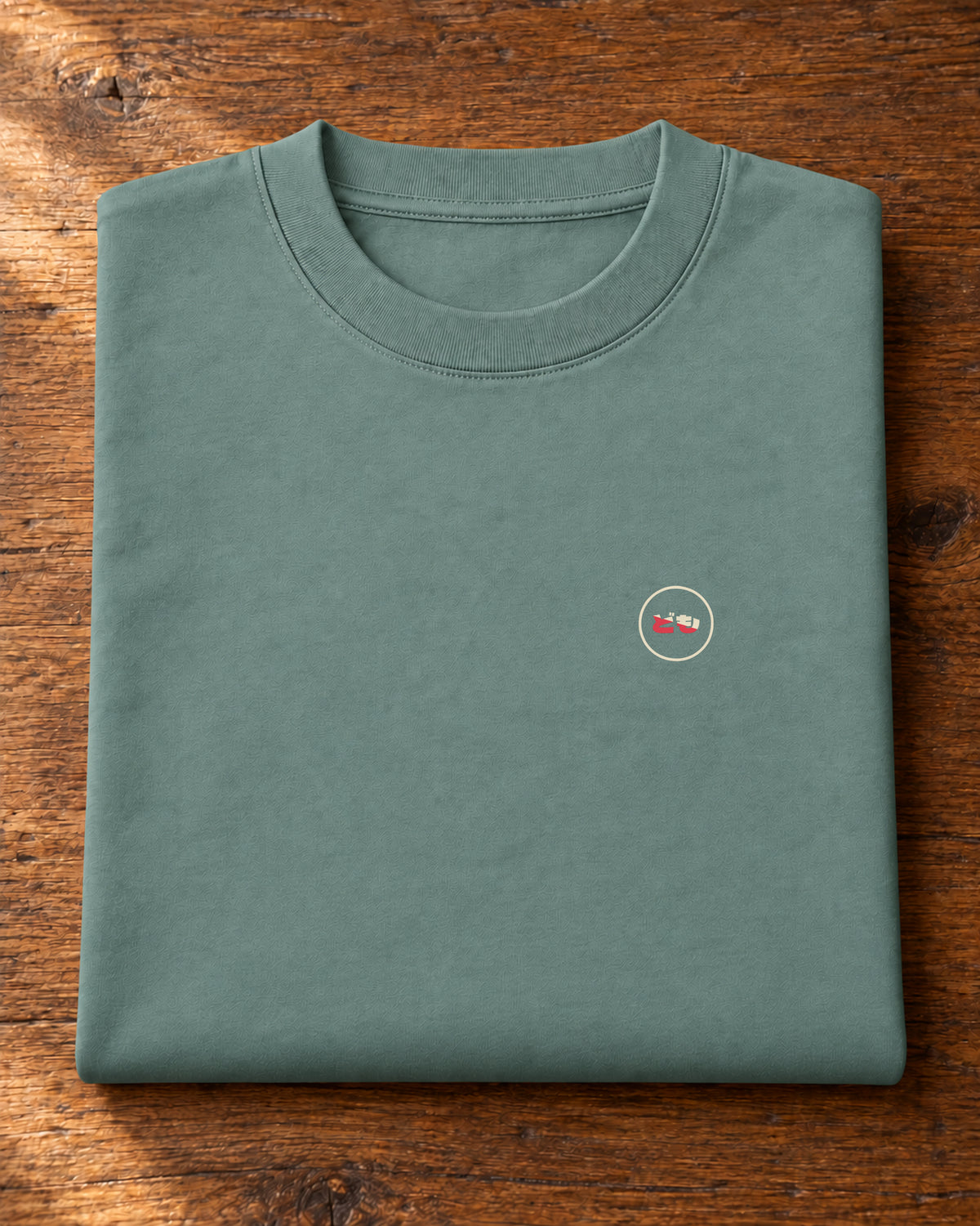 Fudō Tee 不動 | Ink — folded garment showing the Domo chest logo