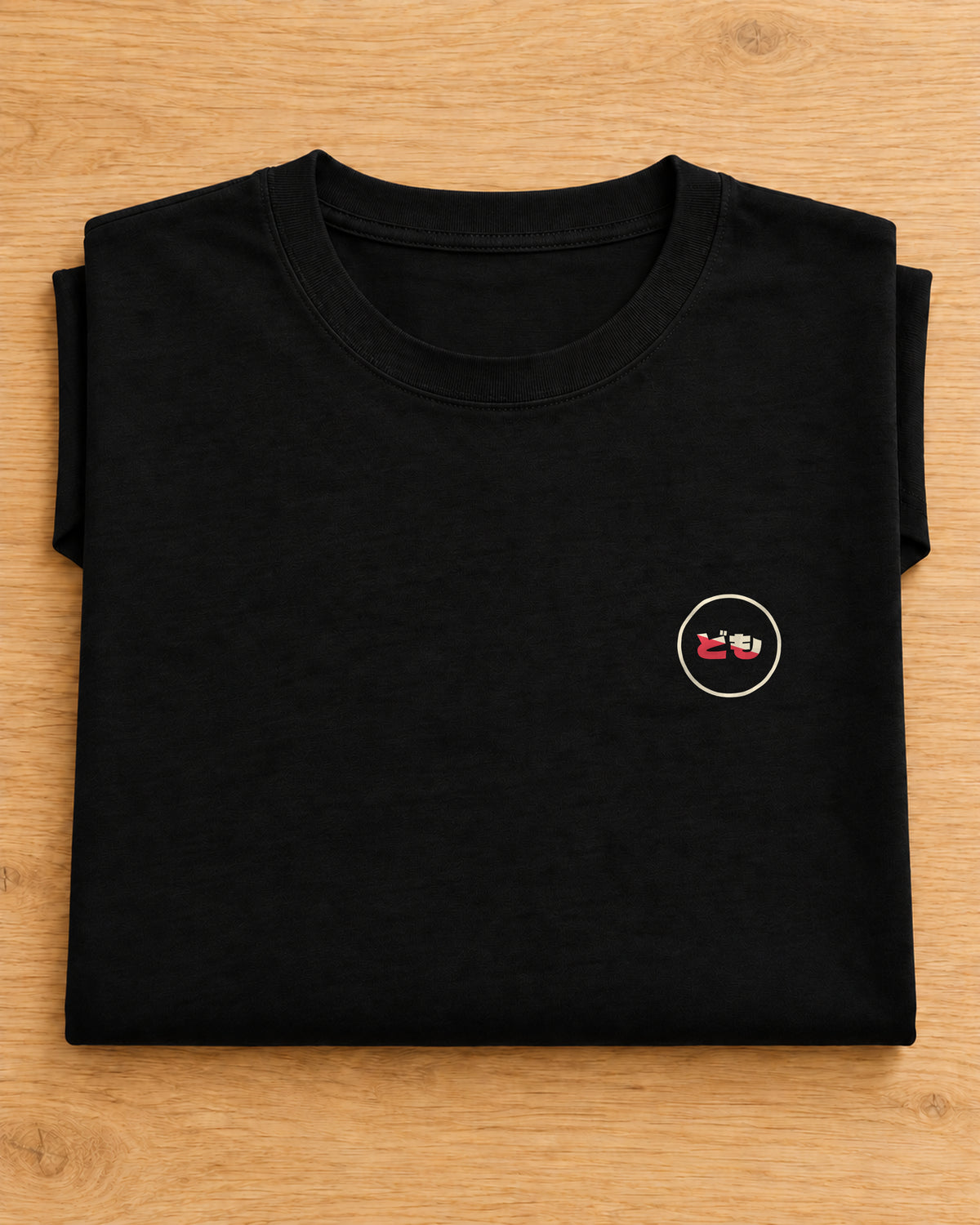 Kata Tee 型 | Origin Dark — folded garment showing the Domo chest logo