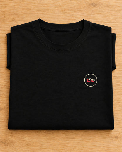 Kata Tee 型 | Origin Dark — folded garment showing the Domo chest logo