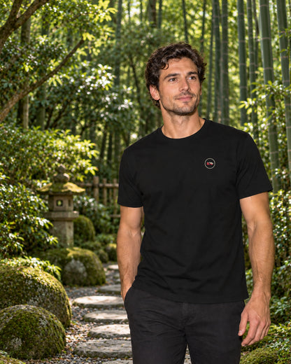 Kata Tee 型 | Zen Dark — front view showing the Domo chest logo in a Japanese setting