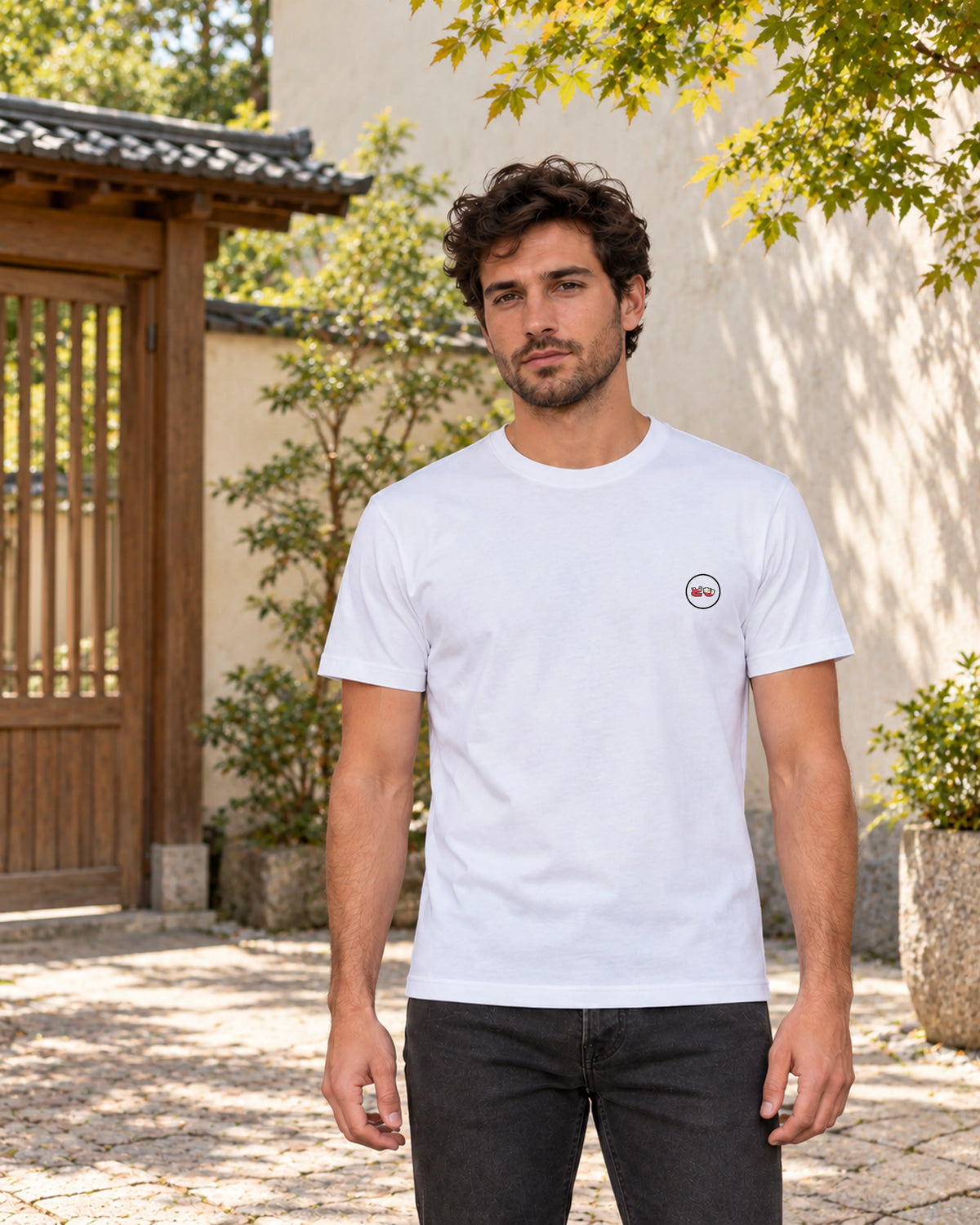 Kata Tee 型 | Zen Light — front view showing the Domo chest logo in a Japanese setting