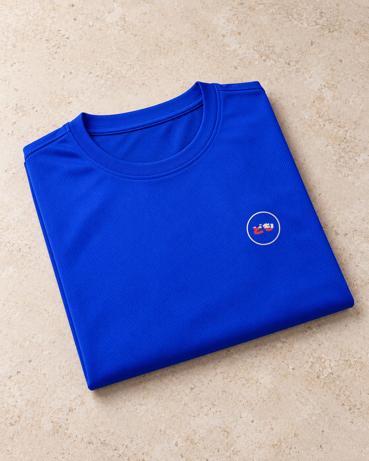 Kaze Sport 風 | Ink — folded shirt showing the Domo chest logo