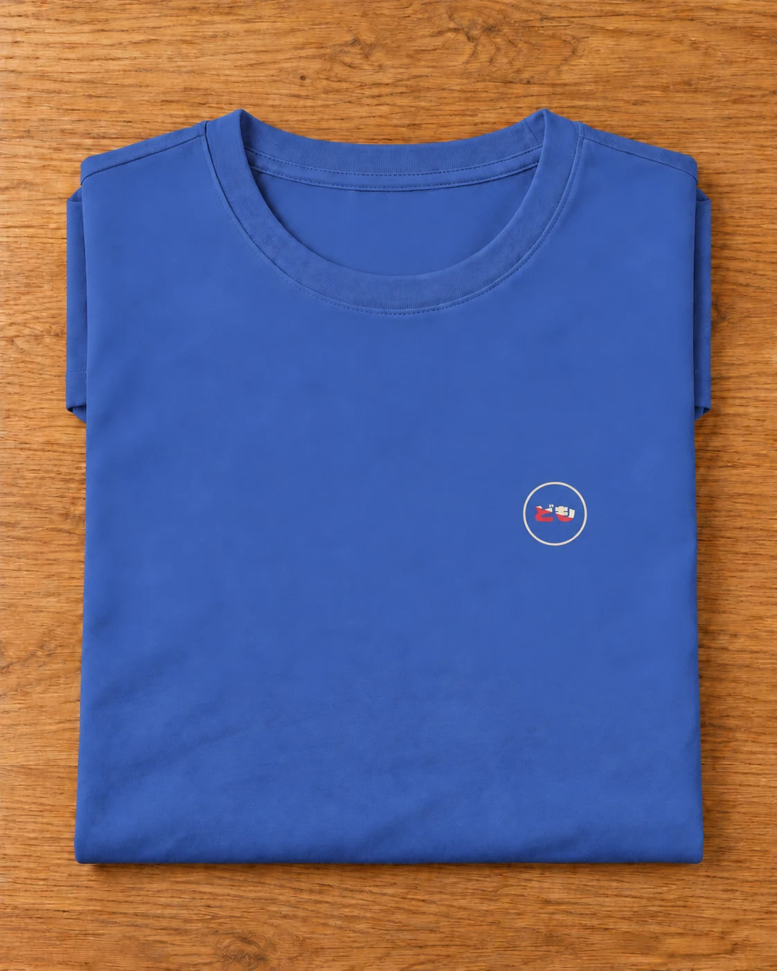 Saki Tee 咲 | Ink — folded garment showing the Domo chest logo