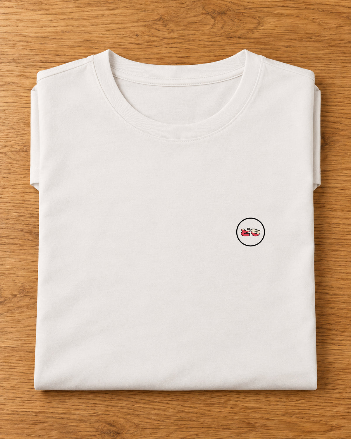 Saki Tee 咲 | Origin Light — folded garment showing the Domo chest logo