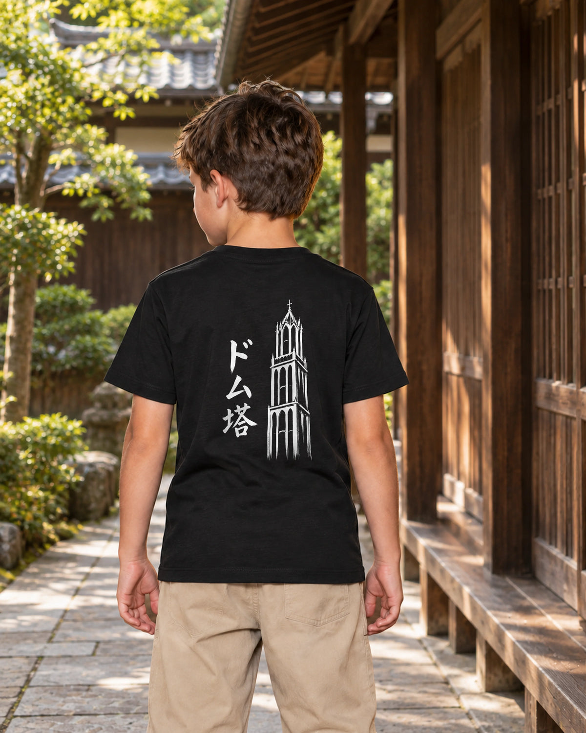 Wakaba Kids Tee 若葉 | Ink — back view showing the artwork in a Japanese wooden courtyard