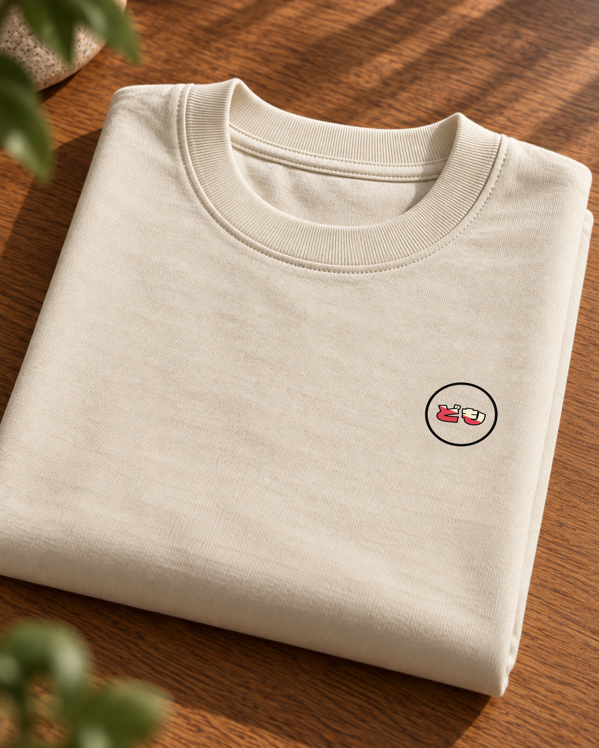 Fudō Tee 不動 | Origin Light — folded garment showing the Domo chest logo