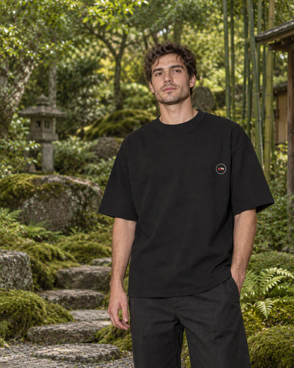 Fudō Tee 不動 | Zen Dark — front view showing the Domo chest logo in a Japanese setting